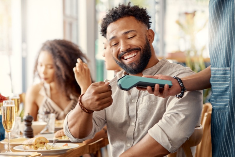 Young man paying with a credit card