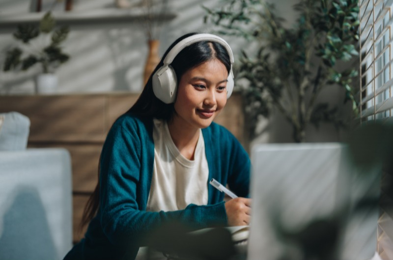 College student studying with headphones