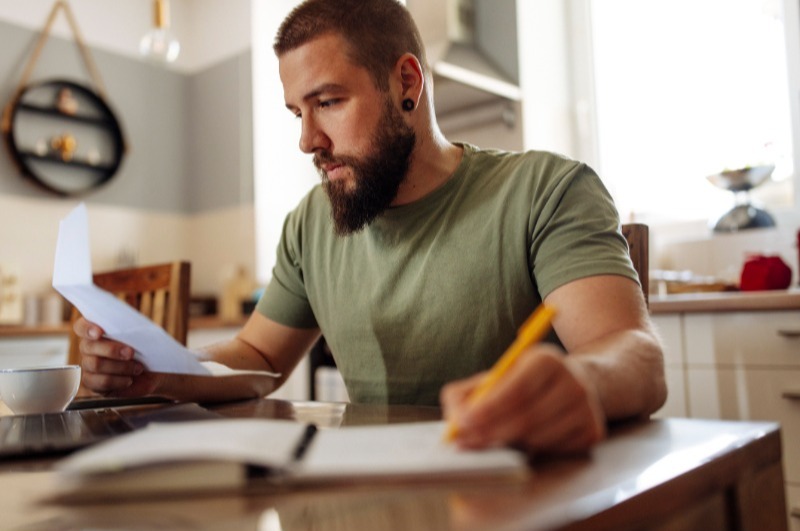 Young man reviewing his finances