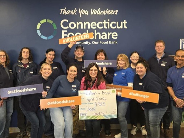 Liberty Bank teammates at CT Foodshare holding signs