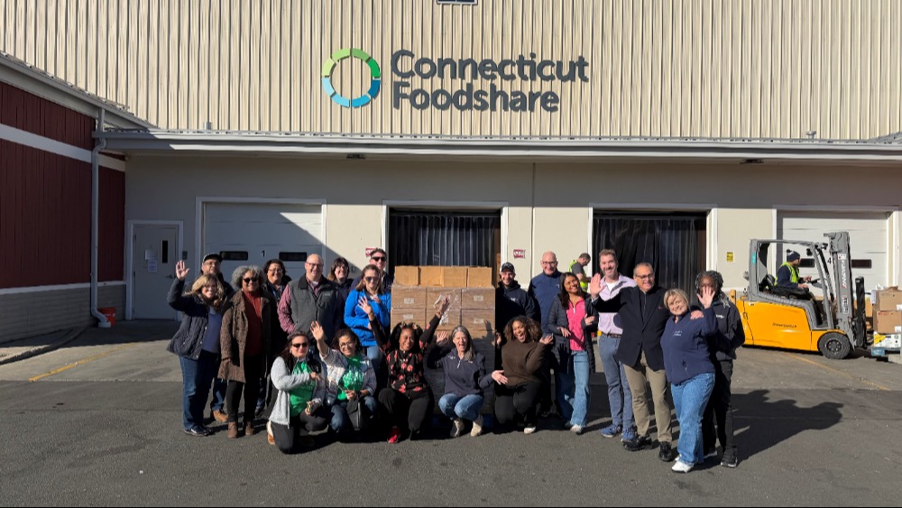 A group of people gather outside Foodshare